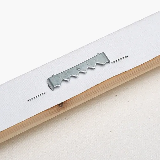 Close-up of metal hanging hardware attached to the back of a canvas frame.